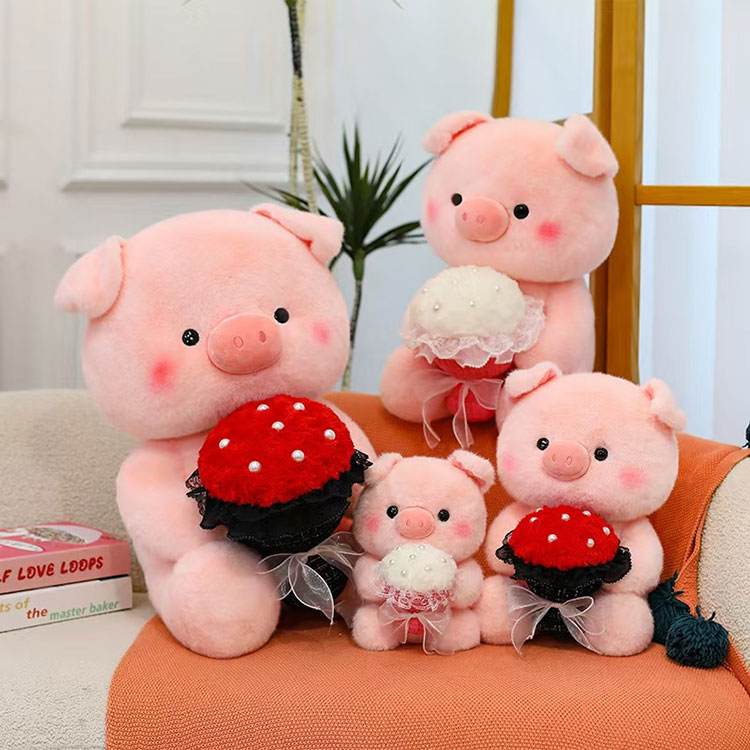 花を持つピンクのブタのぬいぐるみ